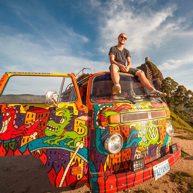 Hippie Van Man in Colombia, sitting on top of his van